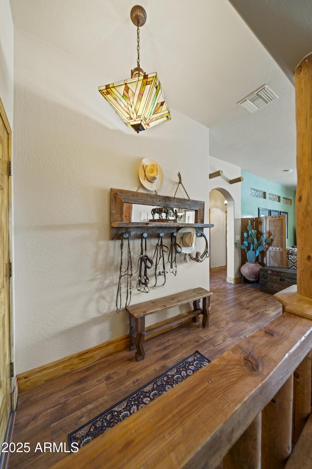 21909 W Beacon Ln, Wittmann, AZ 85361 - dining room with baseboards, arched walkways, wood finished floors, and visible vents