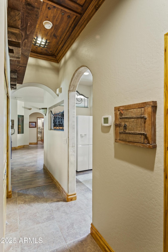 21909 W Beacon Ln, Wittmann, AZ 85361 - hall featuring baseboards, arched walkways, wood ceiling, and tile patterned floors