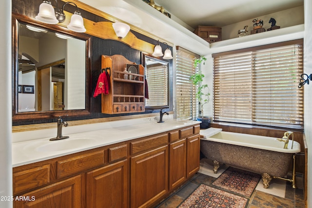 21909 W Beacon Ln, Wittmann, AZ 85361 - bathroom featuring a sink, stone finish floor, a soaking tub, and double vanity