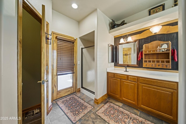 21909 W Beacon Ln, Wittmann, AZ 85361 - bathroom featuring vanity, baseboards, and a stall shower