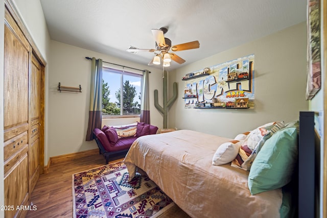 21909 W Beacon Ln, Wittmann, AZ 85361 - bedroom with a ceiling fan, a closet, and wood finished floors