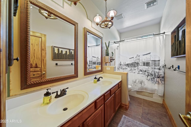 21909 W Beacon Ln, Wittmann, AZ 85361 - full bath featuring visible vents, a sink, double vanity, and toilet