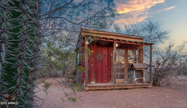 21909 W Beacon Ln, Wittmann, AZ 85361 - outdoor structure at dusk featuring a storage unit and an outdoor structure