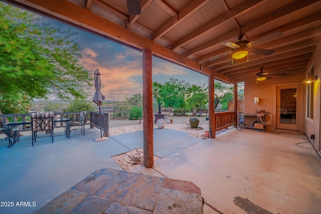 21909 W Beacon Ln, Wittmann, AZ 85361 - patio terrace at dusk featuring a ceiling fan and outdoor dining space