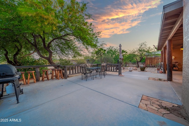 21909 W Beacon Ln, Wittmann, AZ 85361 - patio terrace at dusk with outdoor dining space and a grill