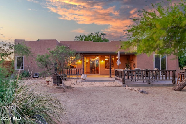 21909 W Beacon Ln, Wittmann, AZ 85361 - back of property at dusk with a patio area and stucco siding