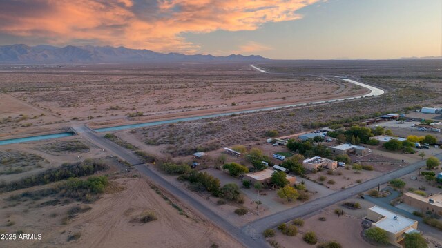 21909 W Beacon Ln, Wittmann, AZ 85361 - aerial view at dusk featuring a mountain view and a desert view