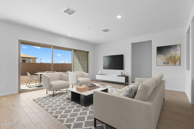 living room featuring recessed lighting, visible vents, baseboards, and wood finished floors