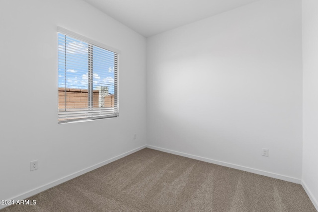 empty room with carpet flooring and baseboards