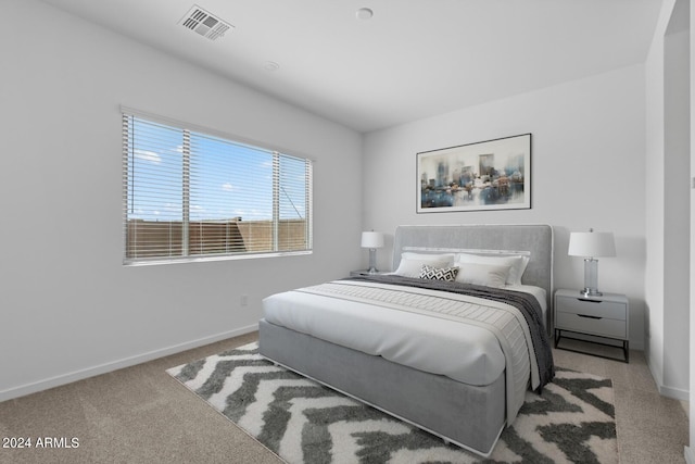 carpeted bedroom featuring visible vents and baseboards