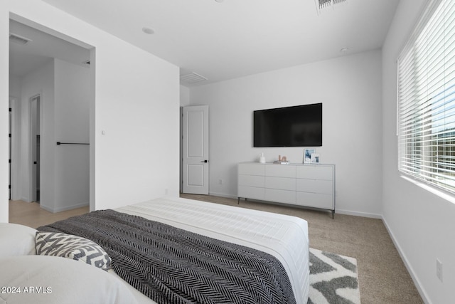 bedroom with carpet, visible vents, and baseboards