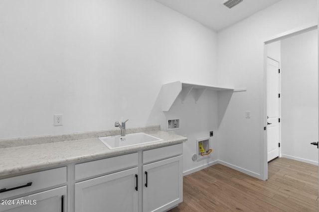 clothes washing area featuring visible vents, a sink, light wood-type flooring, washer hookup, and electric dryer hookup