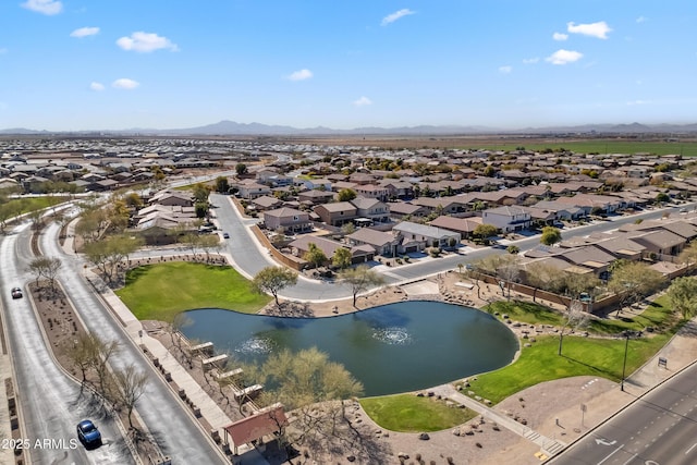 birds eye view of property featuring a water and mountain view and a residential view