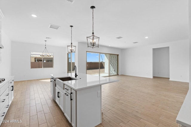 kitchen with light wood-style floors, light countertops, dishwasher, and recessed lighting