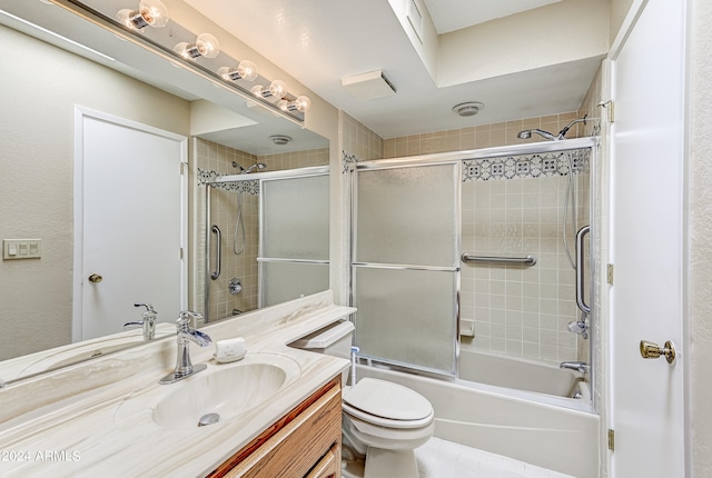 full bathroom with vanity, toilet, and combined bath / shower with glass door