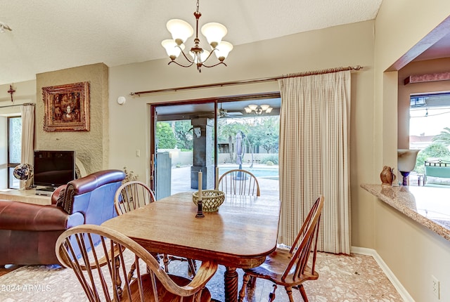 dining room featuring a textured ceiling and a chandelier