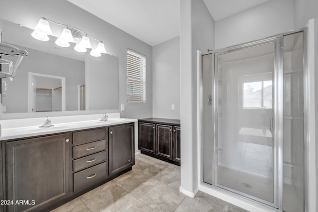 bathroom with tile patterned flooring, vanity, and a shower with shower door