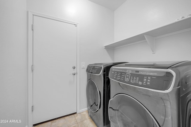 laundry room featuring washer and dryer and light tile patterned floors