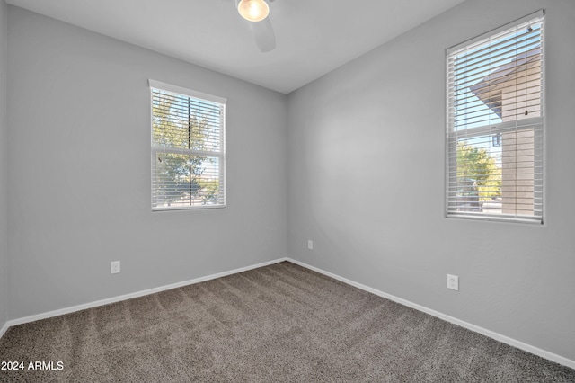 spare room featuring carpet floors, plenty of natural light, and ceiling fan