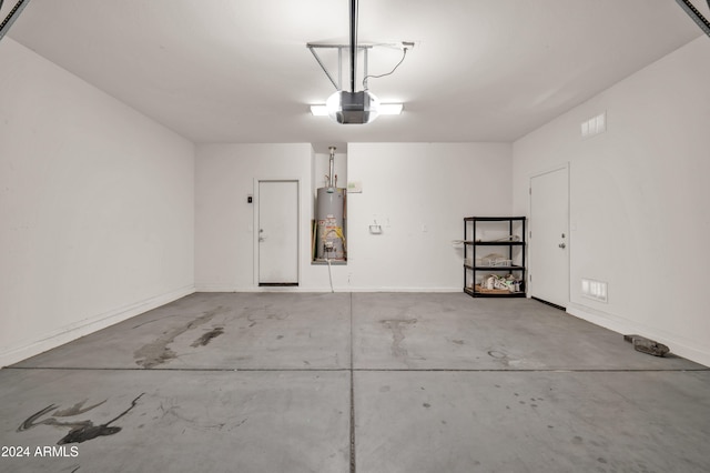 garage featuring gas water heater and a garage door opener