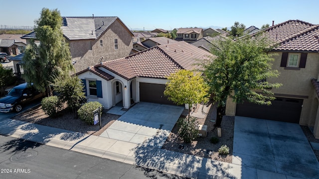 mediterranean / spanish-style home with a garage