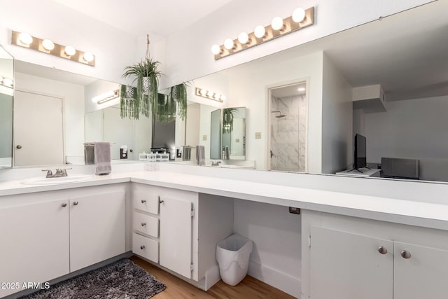 4950 N Miller Rd Unit 200, Scottsdale, AZ 85251 - bathroom featuring a walk in shower, vanity, and wood finished floors