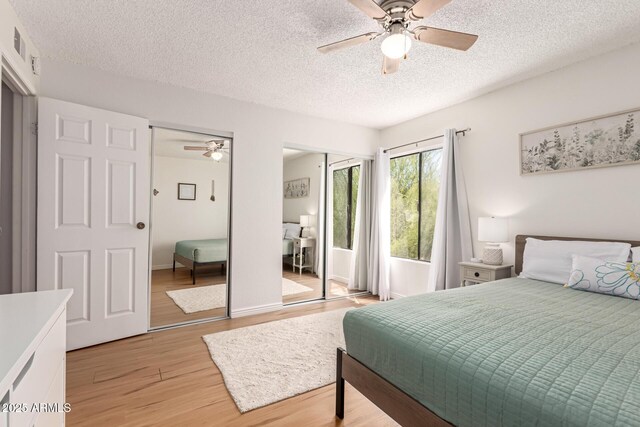 4950 N Miller Rd Unit 200, Scottsdale, AZ 85251 - bedroom with a ceiling fan, light wood-type flooring, and a textured ceiling