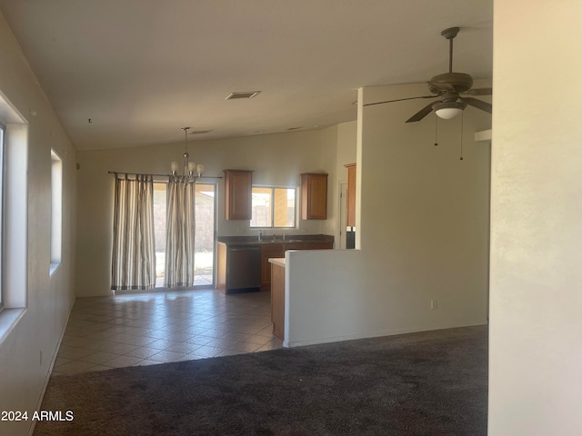 interior space with ceiling fan with notable chandelier, light tile patterned floors, sink, and vaulted ceiling