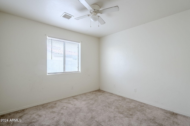 empty room with ceiling fan and light colored carpet