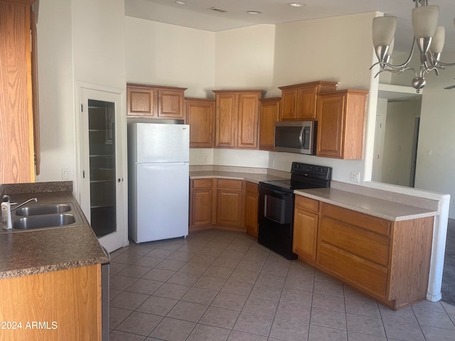 kitchen with black range with electric stovetop, sink, a high ceiling, a notable chandelier, and white refrigerator