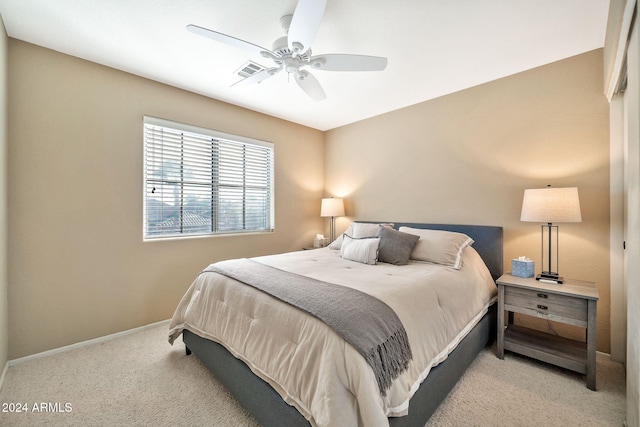 bedroom featuring light carpet and ceiling fan