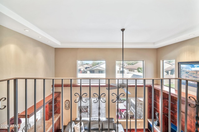 corridor featuring a tray ceiling