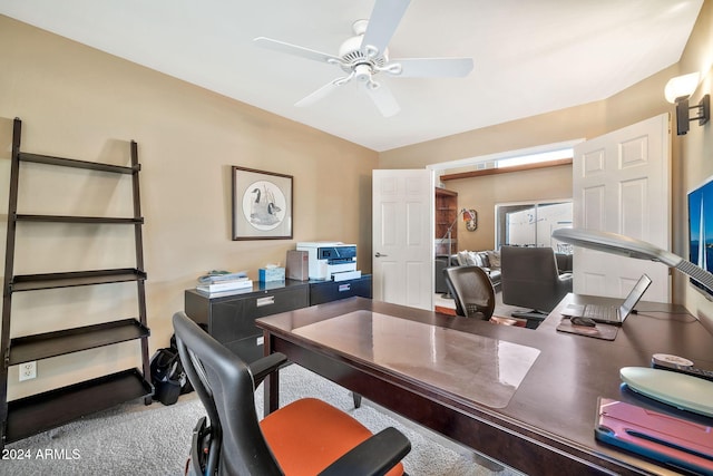 carpeted home office with ceiling fan and lofted ceiling