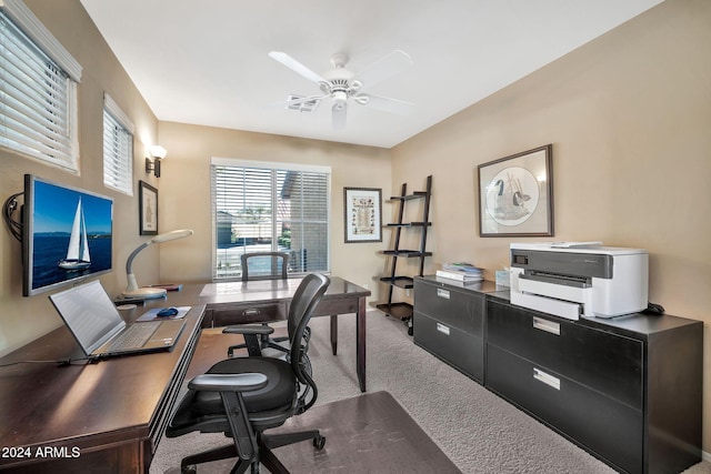 office space featuring ceiling fan and light carpet