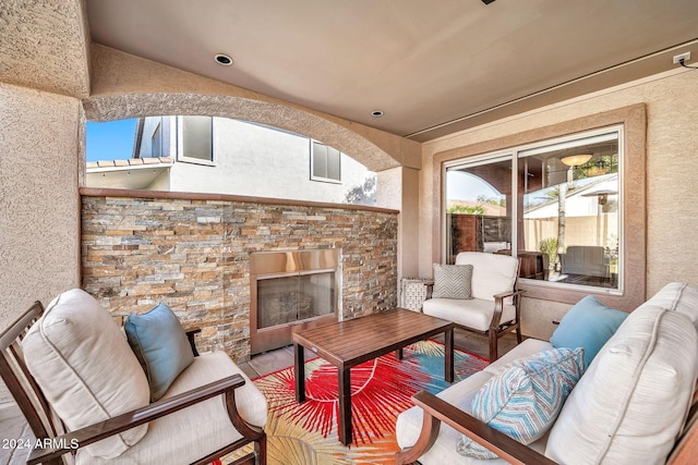 view of patio with an outdoor living space with a fireplace