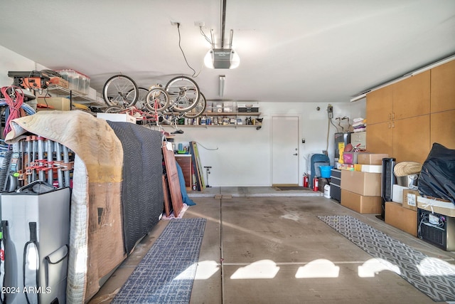 garage featuring electric water heater and a garage door opener