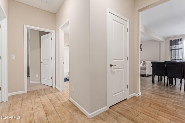 hallway with light hardwood / wood-style flooring