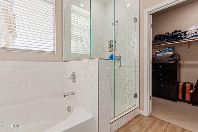 bathroom featuring hardwood / wood-style floors and shower with separate bathtub