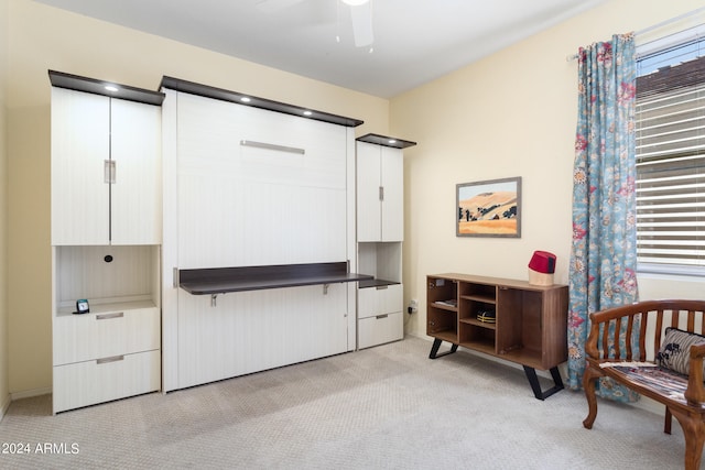 interior space with light colored carpet and ceiling fan