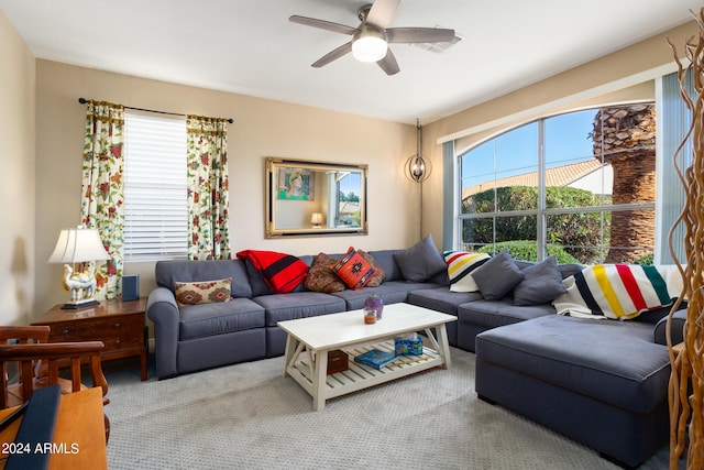 carpeted living room featuring ceiling fan