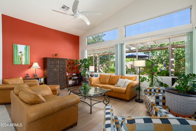 living room featuring vaulted ceiling, ceiling fan, and light wood-type flooring