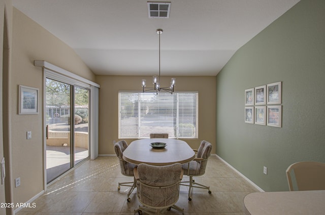 tiled dining room featuring lofted ceiling and a chandelier