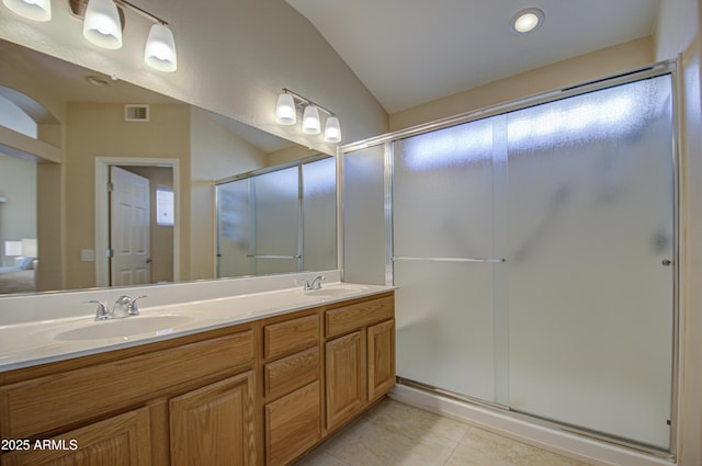 bathroom with tile patterned flooring, vanity, and a shower with shower door