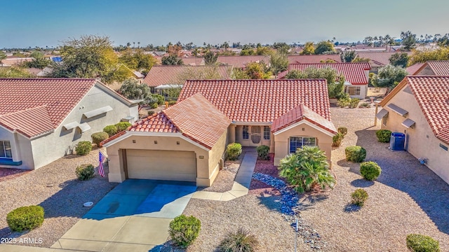 mediterranean / spanish-style home with a garage