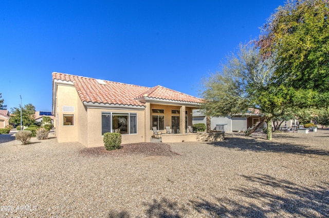 rear view of property featuring a patio