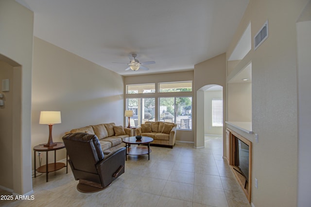 tiled living room featuring ceiling fan