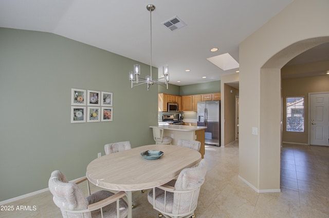 dining room featuring vaulted ceiling, a chandelier, and light tile patterned flooring