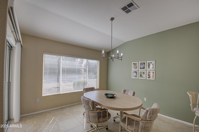 tiled dining room with vaulted ceiling and a chandelier