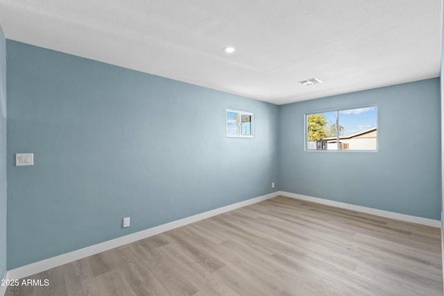 spare room with light wood-type flooring