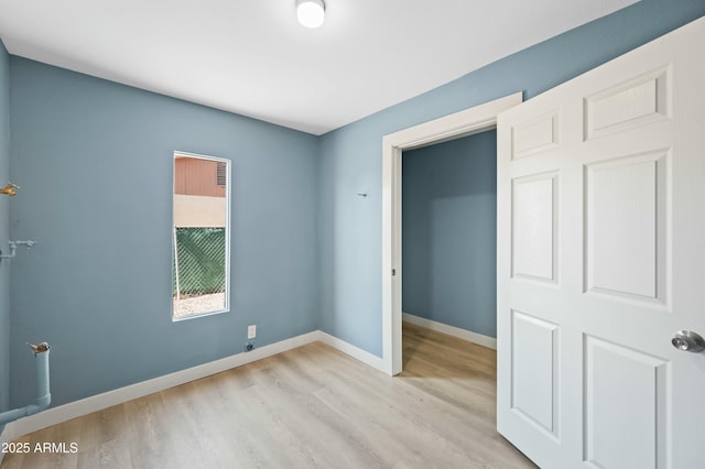 empty room with light hardwood / wood-style floors